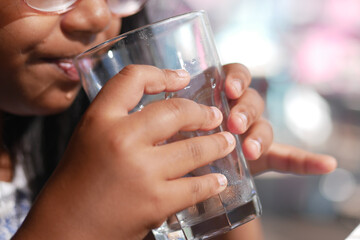 Child enjoys refreshing drink during sunny afternoon