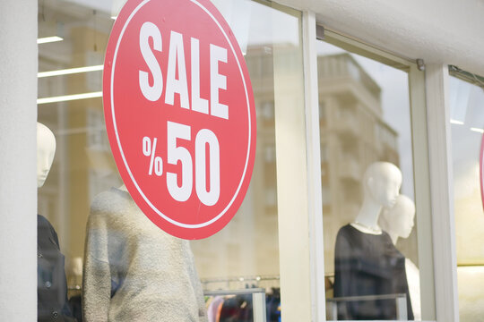 Sale sign in store window showcasing 50 percent discount