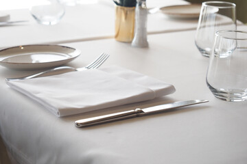 Elegant dining setup with utensils on a white table