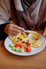 Tasty breakfast: omelette and fresh veggies