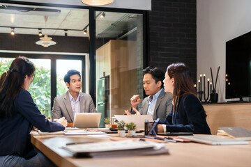 Male mature asian ceo businessman leader with coworkers team, executive managers group at meeting. Asian professional businesspeople working together on research plan in boardroom.