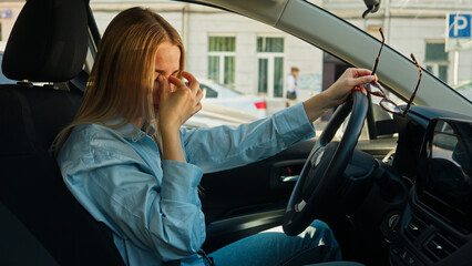 Tired woman driving take off eyeglasses vision rubbing eyes car girl female traffic jam auto...