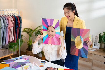 Young Asian woman doing personal color diagnosis by Face frames Color Season Kit for determining...