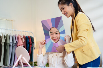 Professional doing personal color analysis . An Asian woman receives a personal color diagnosis...