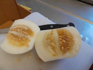 Muskmelon healthy delicious fruit slices by knife. Honeydew melon healthy nutritional raw fruit pieces with knife. Hami melon sweetable juicy food. 