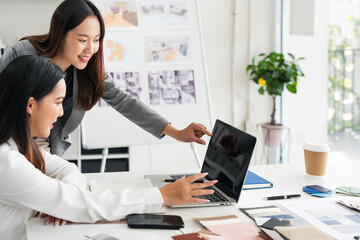 Two young female interior designer or architect working on creative project with drawing, material...