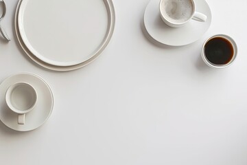 A White Table with a White Plate of Coffee Cups and a White Plate with a White Plate That Says Quot