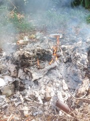 Sungai Petani, Kedah, Malaysia – July 5, 2025 – A pile of mixed trash burning in an open field...