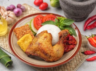 Pecel ayam or penyet ayam or fried chicken in Indonesia is the name of a typical Javanese food...