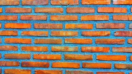 Red brick wall texture background. A patterned red brick wall texture arranged aesthetically. Red...