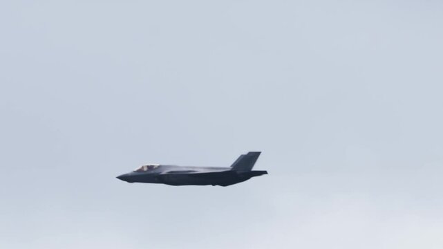 F-35 Lightning Stealth Fighter Closeup Tracking Shot with Vapor Trails. 