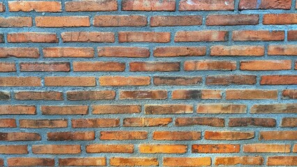 Red brick wall texture background. A patterned red brick wall texture arranged aesthetically. Red brick walls built in a house in the countryside with classic architecture. High resolution images.