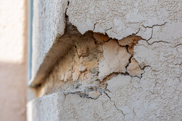 Weathered wall with visible fissures and mold, concept of aging infrastructure and maintenance issues
