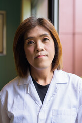 Transgender non binary doctor face closeup in office