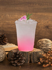Pink Italian Soda A drink made with red syrup, such as strawberry, lychee, or pomegranate, mixed with soda and ice, and garnished with flowers or herbs, such as rosemary.