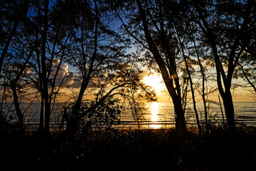 Sunrise on sea and silhouette of pnie © suthin3