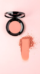 Elegant blush palette presents a perfect peach tone for complexion enhancing makeup, showcased against a soft pink backdrop.