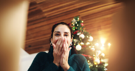 Christmas, surprise and happy woman with gift box in low angle for festive celebration. POV, xmas...