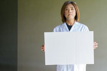 Confident transgender non-binary person in lab coat and protective glasses