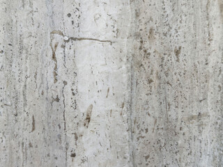 Rustic textured beige marble surface with natural veins and stains