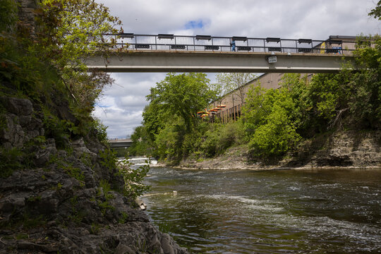 Fergus - town in Ontario on the Grand River, popular tourist town with beautiful old stone houses, a waterfall, and ancient bridges. A tourist magnet. Summer sunny day with cloudy sky. Ontario, Canada