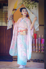 Pretty young Asian Japanese woman in a Traditional Furisode Kimono Yukata dress costume. A young...