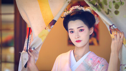 Pretty young Asian Japanese woman in a Traditional Furisode Kimono Yukata dress costume. A young...