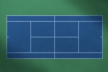 Overhead view of empty blue badminton fieldagainst green background