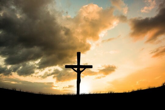 Fototapeta Cross religion symbol shape over sunset sky