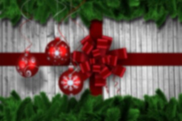 Christmas baubles hanging over wood