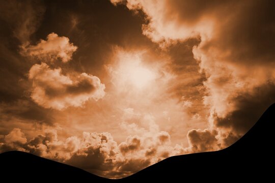 Fototapeta Flat design showing golden sky with bright sun shining through billowing clouds over rolling hills