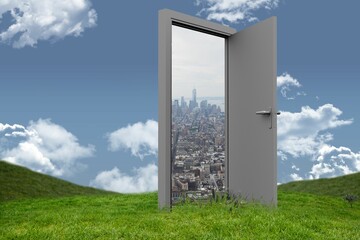 Obraz premium Door opening at cityscape on grassy hill