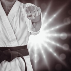 Midsection of martial artist punching fist
