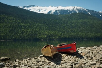 Naklejka premium Kayaks by lake on sunny day