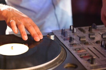 Midsection of DJ mixing sound © vectorfusionart