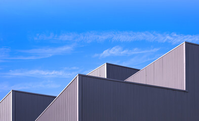 Factory Warehouse Industry Building Background, Architecture Exterior Geometric Metal Wall of Modern Gray Aluminum Rooftop with Blue Sky in Minimal Design, Perspective Low angle view