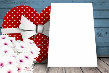 Flowers and present box on wooden background