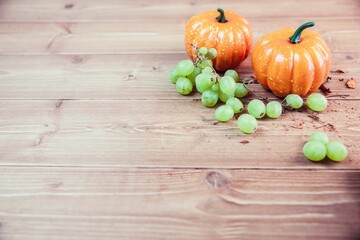 Pumpkins and grapes on table