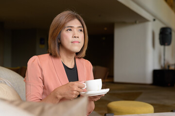Confident transgender non binary person in smart business attire at stylish indoor cafe restaurant