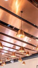 Polished Copper Ceiling Panels Reflecting Warm Pendant Lamp Glow in Interior Space