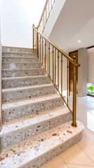 Polished Terrazzo Stairwell With Brass Handrail and Reflections Vertical Composition in Modern Architectural Interior