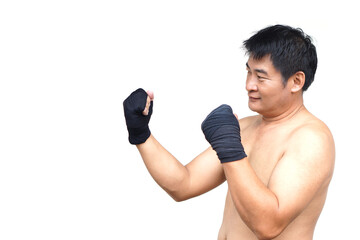 A confident Thai male boxer prepares for training with black hand wraps in a traditional fighting stance, isolated on white background. Concept, art of Muay Thai as a powerful self-defense practice.
