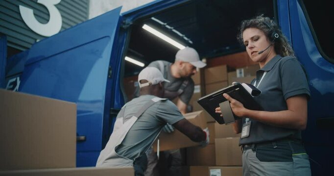 Outside of Logistics Warehouse: Diverse Employees Loading Delivery Truck with Cardboard Boxes, Online Orders, Purchases and E-Commerce Goods. Female Manager Using Digital Tablet and Barcode Scanner.