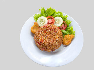 ried rice or nasi goreng is is a food made from fried rice originating from Asia served cucumber, sausage, nuggets, tomatoes. isolated on white background