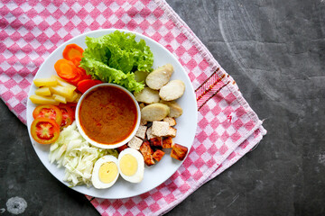 Gado-gado is a traditional Indonesian salad consisting of vegetables, potatoes, tempeh, tofu,...