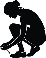 Silhouette of a woman tying her shoelaces before a run