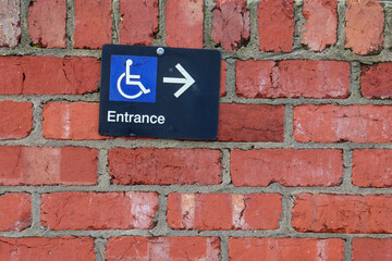 handicap wheelchair entrance direction sign