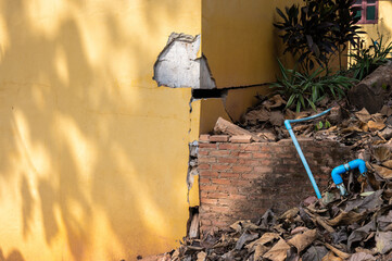 Cropped shot view of cracked building. Wider cracks often represent serious structural damage and...