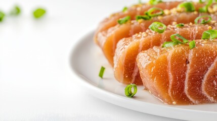 Delicious fresh salmon sashimi slices are arranged artfully on a white plate, garnished with green onions and sesame seeds ready to be savored and enjoyed now.