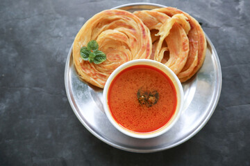 Roti Canai or Paratha Bread with Curry Sauce, Chilli Flakes and Yogurt, Top View